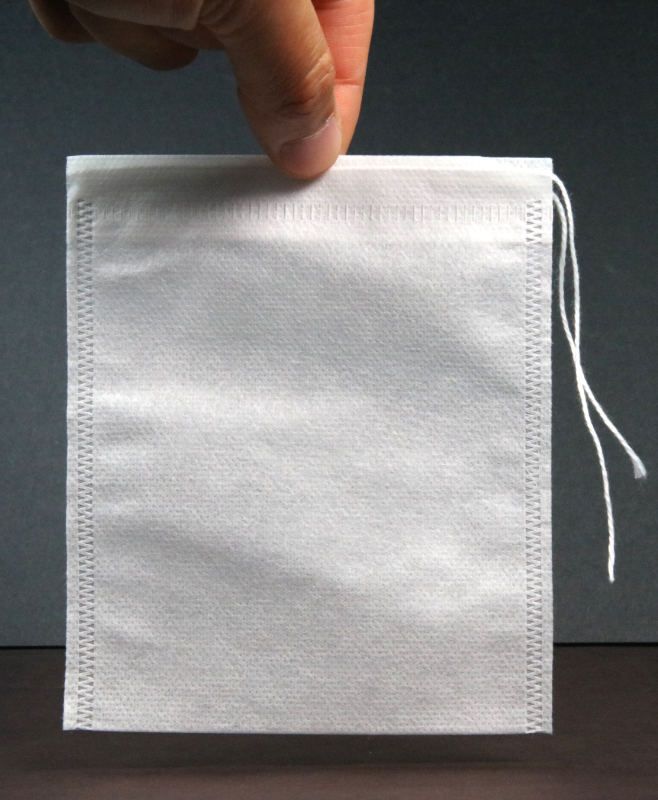Filter Bag with string, held by fingers.