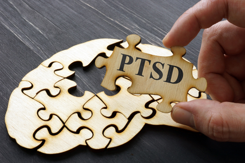 graphic of a wooden puzzle with a piece missing that says PTSD on it