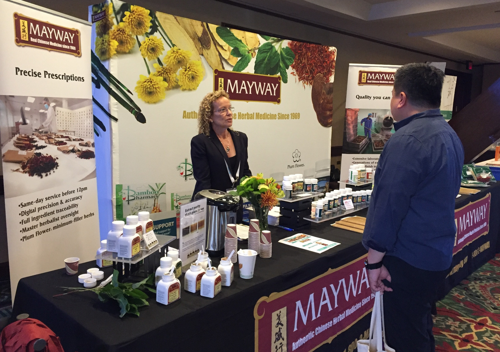 photo of Janet Borges in front of the Mayway booth