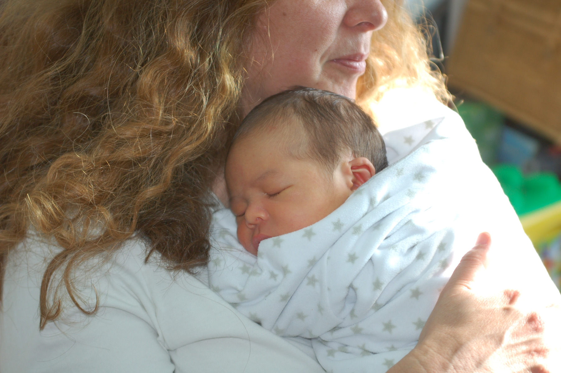 Photo of a woman holding a newbord baby