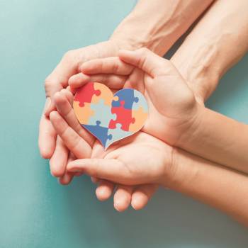 Graphic of puzzle indicating autism spectrum disorder in two hands