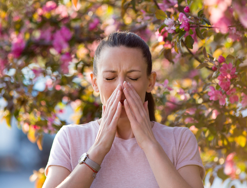 Image of a woman sneezing