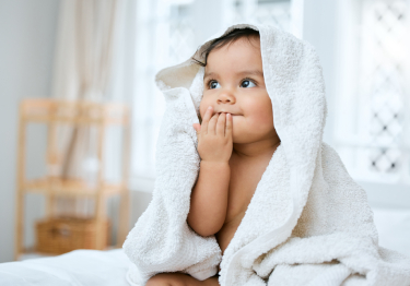 photo of a baby with a towel over their head