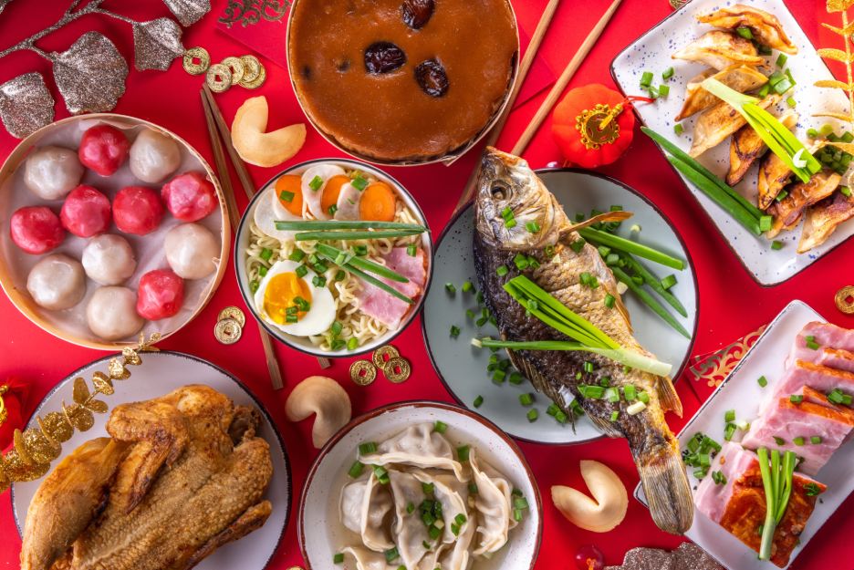 Photo of Chinese new year meal with fish and eggs and dumplings