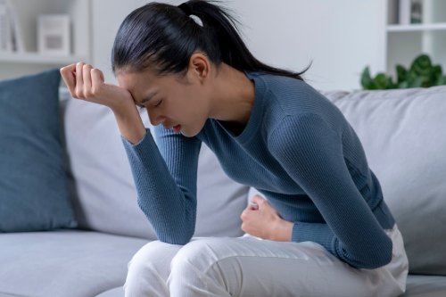 photo of a woman that is in pain from premenstrual symptoms