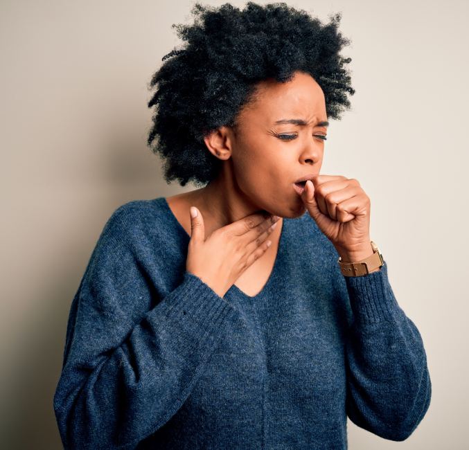 photo of a woman coughing